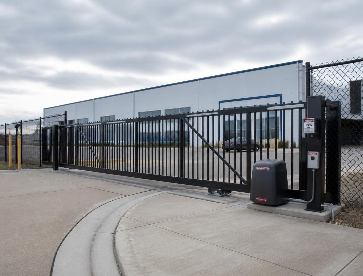 Heavy-duty commercial sliding security gate with operator at a business property